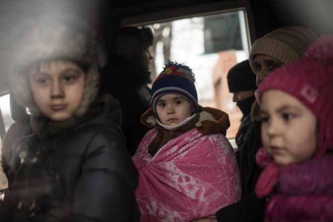 Ukrainian children look through a window of a bus near Artemivsk, eastern Ukraine, on February 5, as people are evacuated.