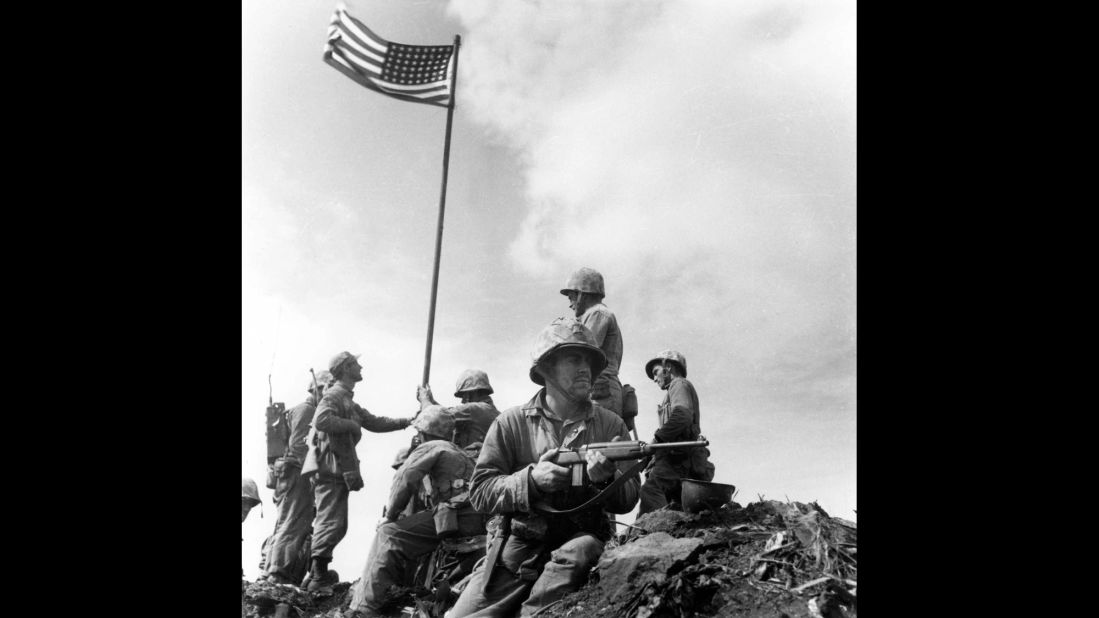 Marine Sgt. Louis Lowery, a photographer for Leatherneck magazine, captured this image of Marines raising an American flag for the first time atop Iwo Jima's Mount Suribachi on February 23, 1945. A strange series of events, however, made this photo less well-known than Rosenthal's.