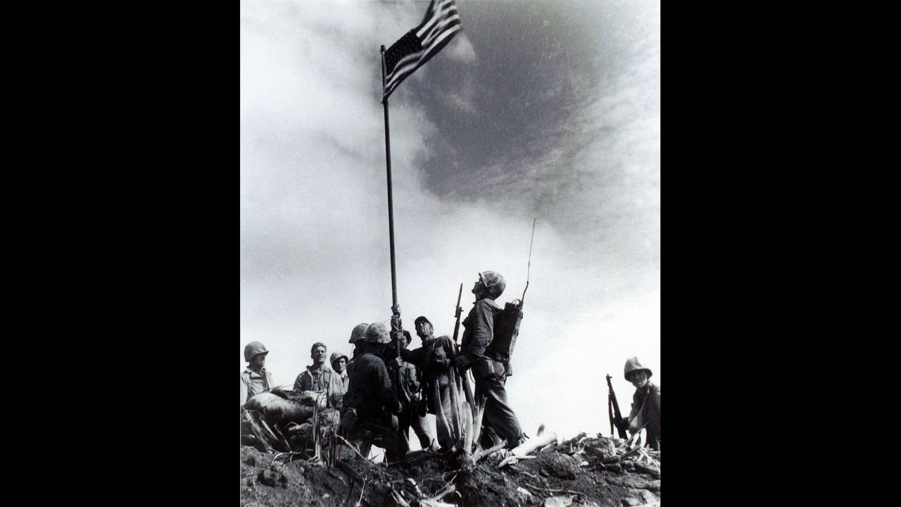 Another Lowery image of the first flag-raising. A short time later, the Marines were ordered to replace the first flag with a bigger one so more people could see it.