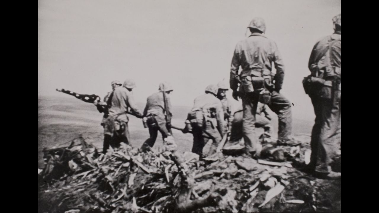 This image, from a 16mm film shot by Marine Sgt. William Genaust, shows Marines beginning to raise the second flag.