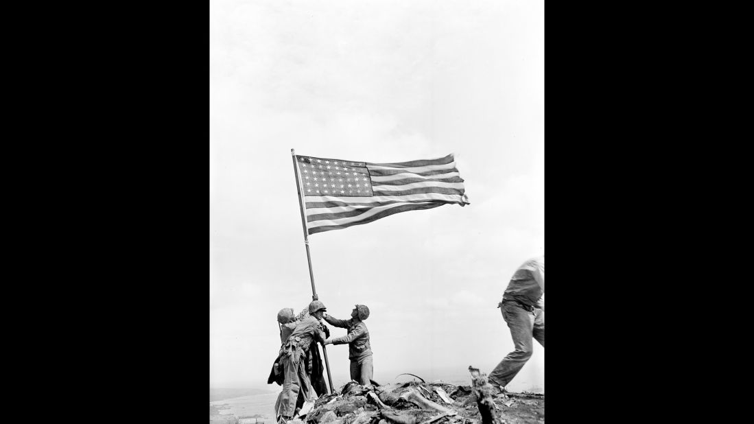Rosenthal took this image of three men holding the flagstaff. During the flag-raising, the area was still a dangerous combat zone. Japanese soldiers were hiding throughout the island.