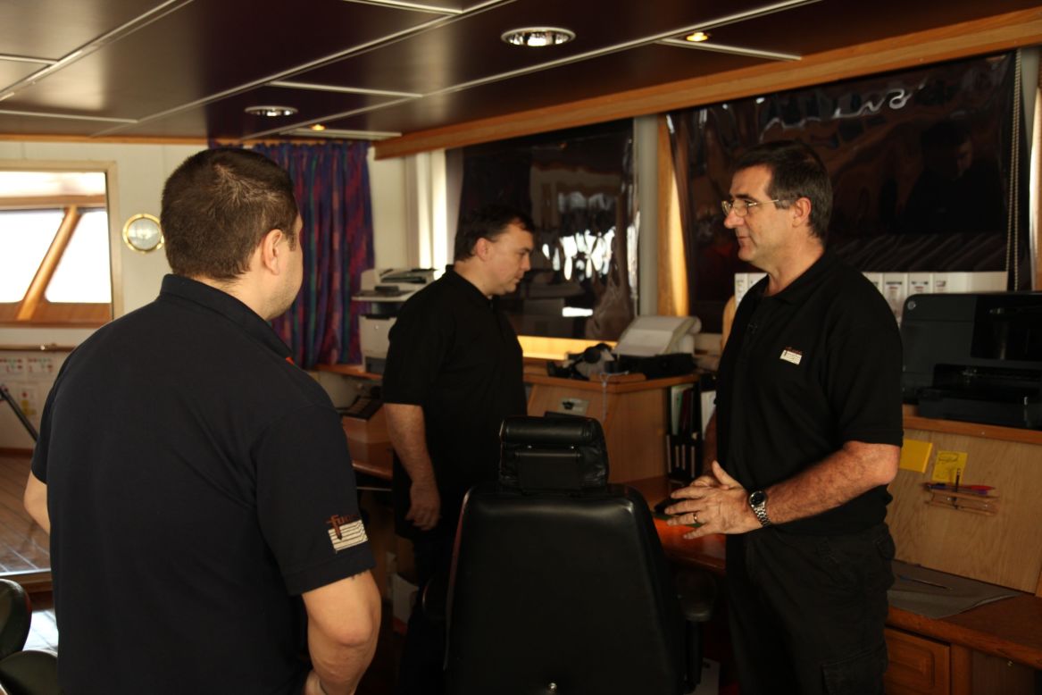 Party Chief, the official title for the person in charge of the survey, Chris Morris (left) talks with Captain Vladimir Konstantinov (center), who has skippered the Discovery for the past six weeks.