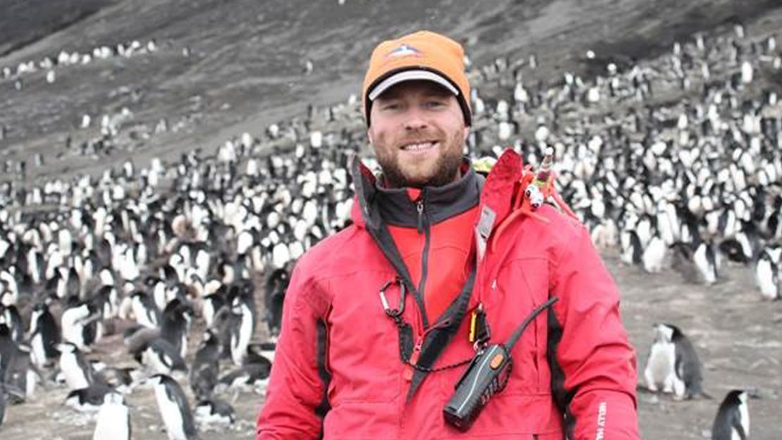 Tom Hart with a chinstrap penguin colony on the Saunders Island in the South Sandwich Island archipelago.