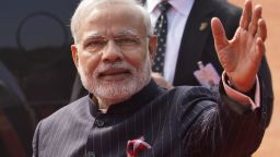 In this Jan.25, 2015 photo, Indian Prime Minister Narendra Modi wears a dark pinstriped suit with his name monogrammed in dull gold stripes during a reception to U.S. President Barack Obama in New Delhi, India. The suit which became controversial after its photographs went viral on social media was to be auctioned in his home state of Gujarat, over the next three days starting Wednesday, Feb.18, 2015 officials said. (AP Photo/Saurabh Das)