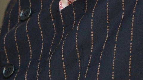 This close-up shows the details of the Indian Prime Minister Narendra Modi's suit bearing his own name.  