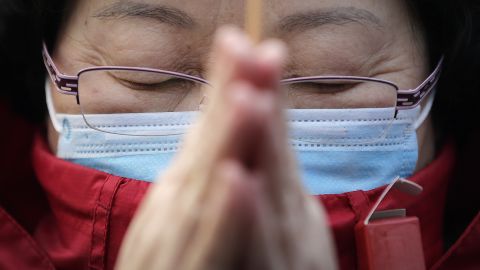 A woman prays in Beijing on February 19.