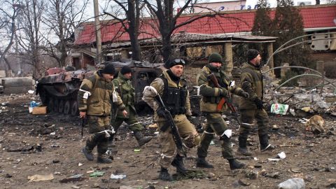 Pro-Russia rebels walk in Debaltseve, eastern Ukraine on Thursday, Feb. 19, 2015. After weeks of relentless fighting, the embattled Ukrainian rail hub of Debaltseve fell Wednesday to Russia-backed separatists, who hoisted a flag in triumph over the town. The Ukrainian president confirmed that he had ordered troops to pull out and the rebels reported taking hundreds of soldiers captive. (AP Photo/ Peter Leonard)