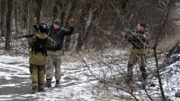 Two pro-Russian seperatists stop a man holding his arms up in the eastern Ukrainian city of Uglegorsk, 6 kms southwest of Debaltseve, on February 19, 2015.