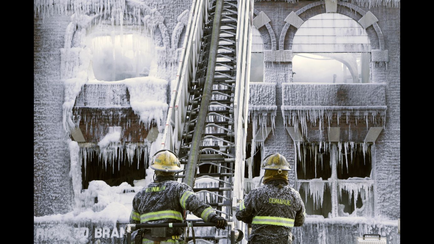 Philadelphia firefighters work at the scene of an overnight blaze on Monday, February 16. The cold weather made icicles out of their water.