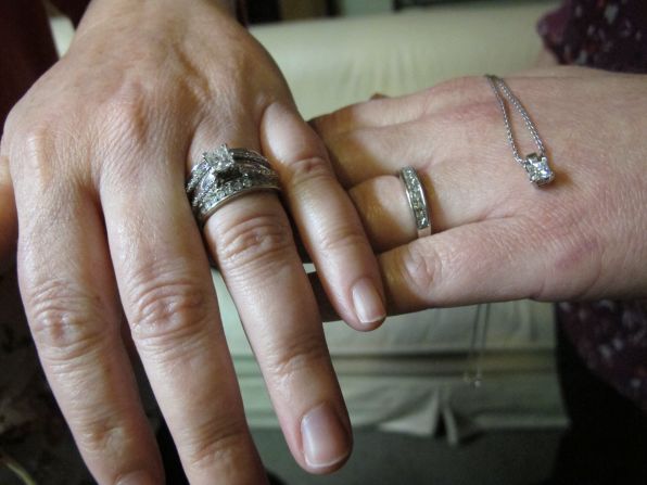 With no traditions in place for same-sex marriage, Lisa Carmichael and Meredith Miller proposed to each other at separate times in 2009. Miller gave Carmichael a more tradition ring, but because Miller doesn't care for rings, she got a smaller band with a solitaire matching Carmichael's dangling from a necklace.