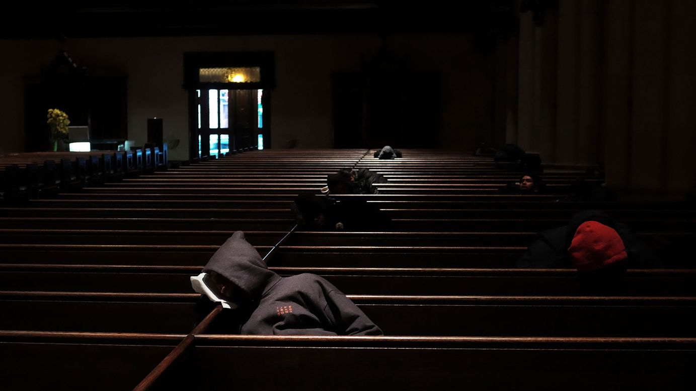 Homeless people find warmth at a New York church on Friday, February 13, which was a bitterly cold day in the city.