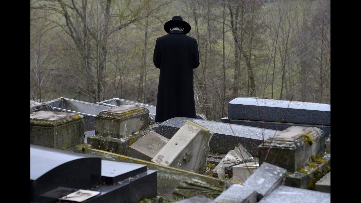A member of the Jewish community looks at broken tombstones in Sarre-Union, France, on Tuesday, February 17. About 250 Jewish graves <a href="http://www.cnn.com/2015/02/16/world/gallery/france-jewish-cemetery/index.html" target="_blank">had been defaced,</a> with most of the damage consisting of headstones being overturned and columns uprooted. French Prime Minister Manuel Valls sent out a tweet calling the destruction "a vile, anti-Semitic act."