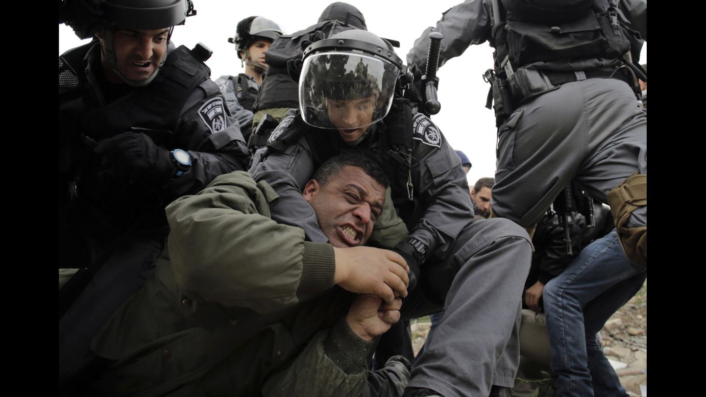Israeli border policemen detain a Palestinian man near the West Bank town of Abu Dis as they clear a land protest on Monday, February 16.
