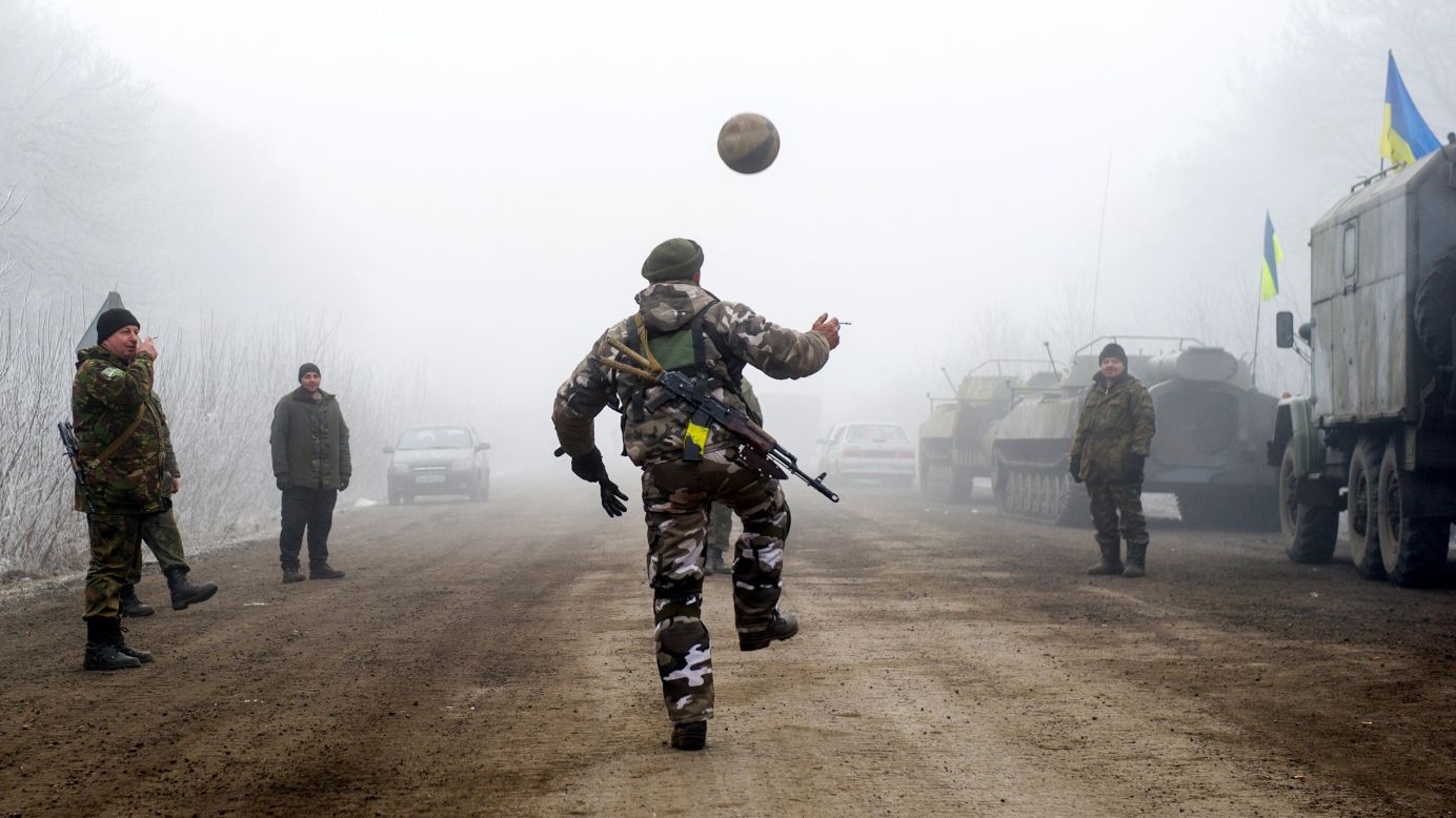Ukrainian servicemen play with a soccer ball on a road between the Ukrainian cities of Svitlodarsk and Debaltseve on Sunday, February 15.