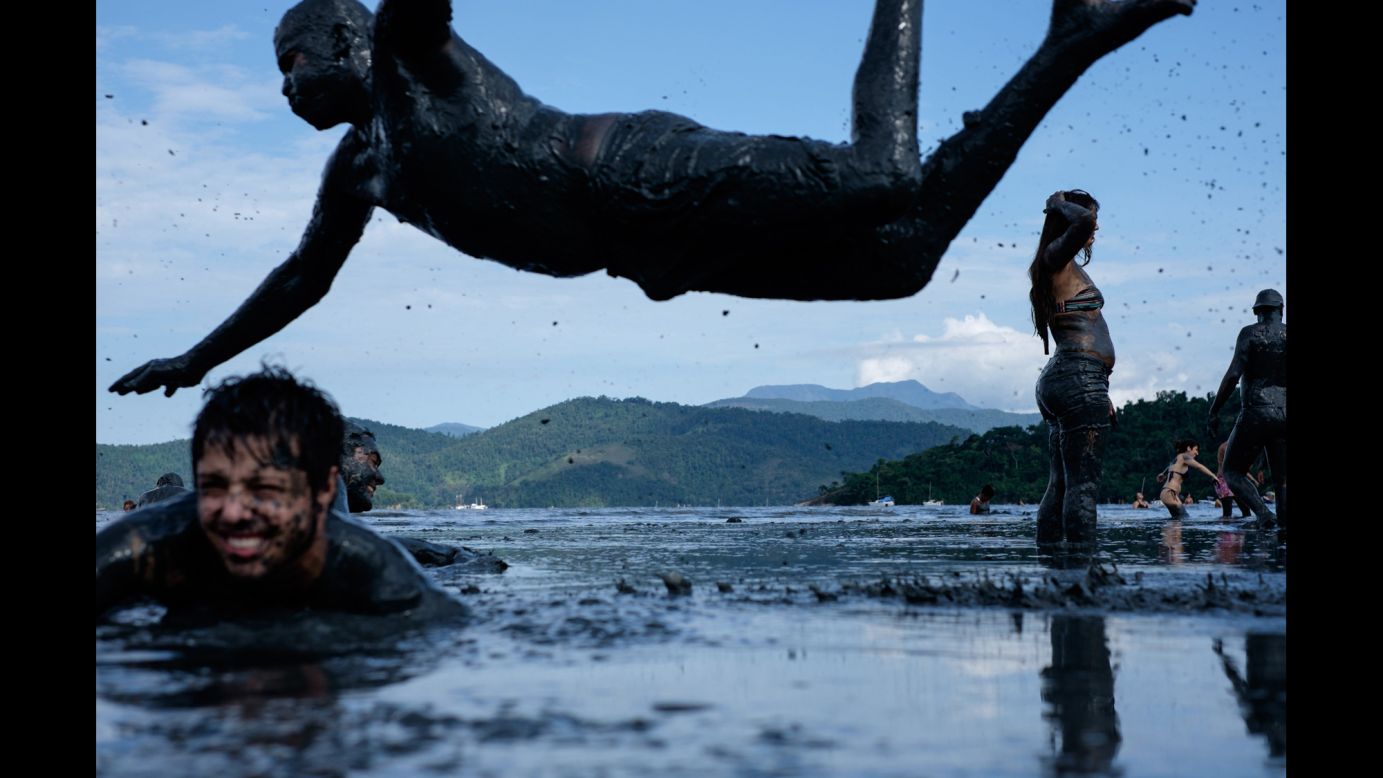 A reveler dives during the Mud Block party, an annual Carnival celebration in Paraty, Brazil, on Saturday, February 14.