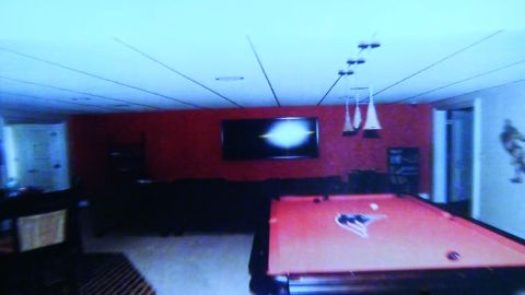 Hernandez's basement "man cave" includes a pool table with a Patriots logo.