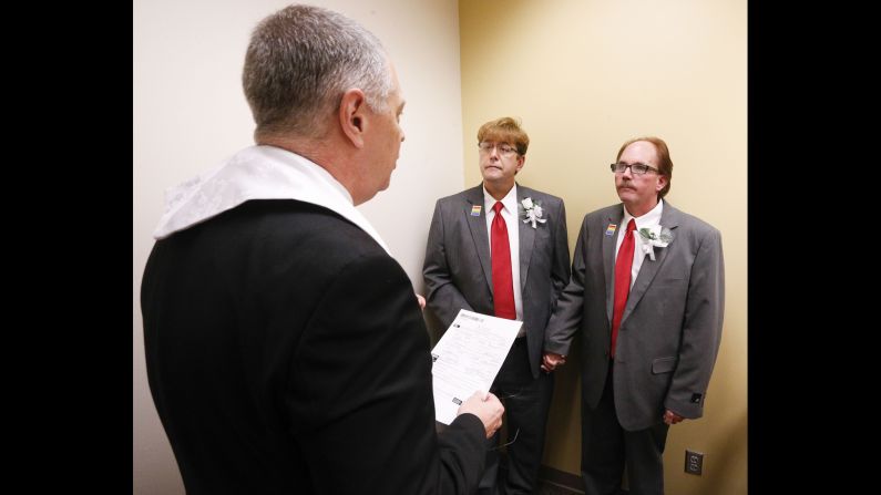 The Rev. Charles Perry of Unity Church marries Curtis Stephens, center, and his partner of 30 years, Pat Helms, at the Jefferson County Courthouse in Birmingham, Alabama, on February 9.