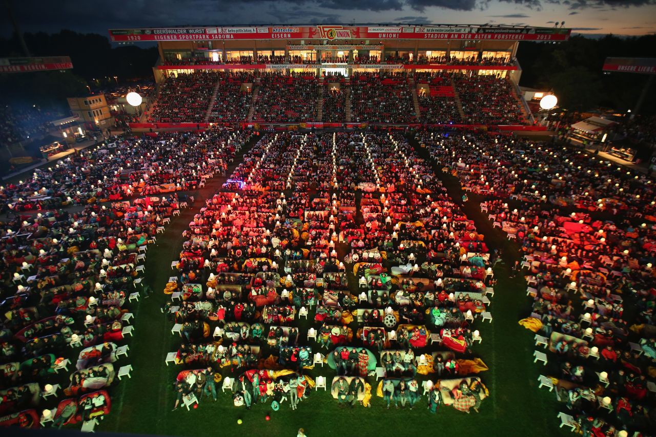 During popular global sporting events like the World Cup, many sports facilities offer events for fans to enjoy live games in a stadium environment. Fans watch the Germany-Ghana World Cup match at the Alte Foersterei FC Union stadium on June 21, 2014 in Berlin. The stadium allowed fans to bring 800 sofas to watch the World Cup matches on a giant monitor. 