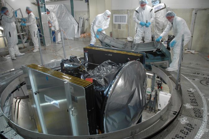 Workers at Cape Canaveral prepare Dawn for launch by removing its transportation canister.  Dawn was then mated with a Delta II rocket.