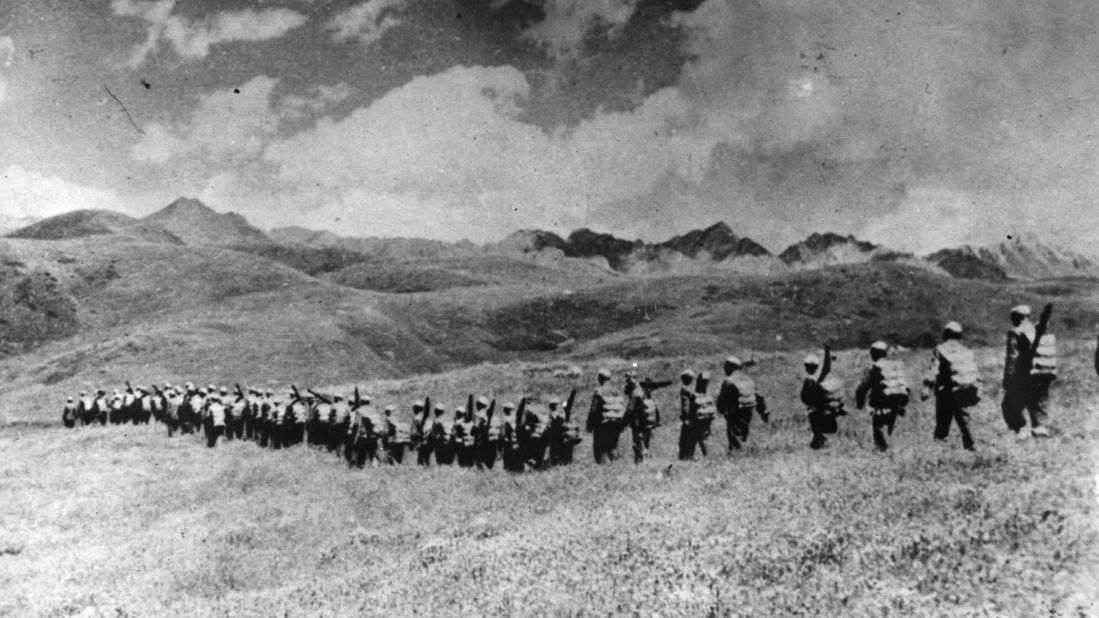 Chinese troops march over the highlands after their invasion of Tibet in 1950. At age 15, the Dalai Lama assumed full political power ahead of schedule. His investiture was moved up from his 18th birthday as a result of China's invasion.