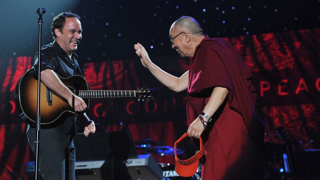 Dave Matthews greets the Dalai Lama on stage at the One World Concert at Syracuse University in New York on October 9, 2012.