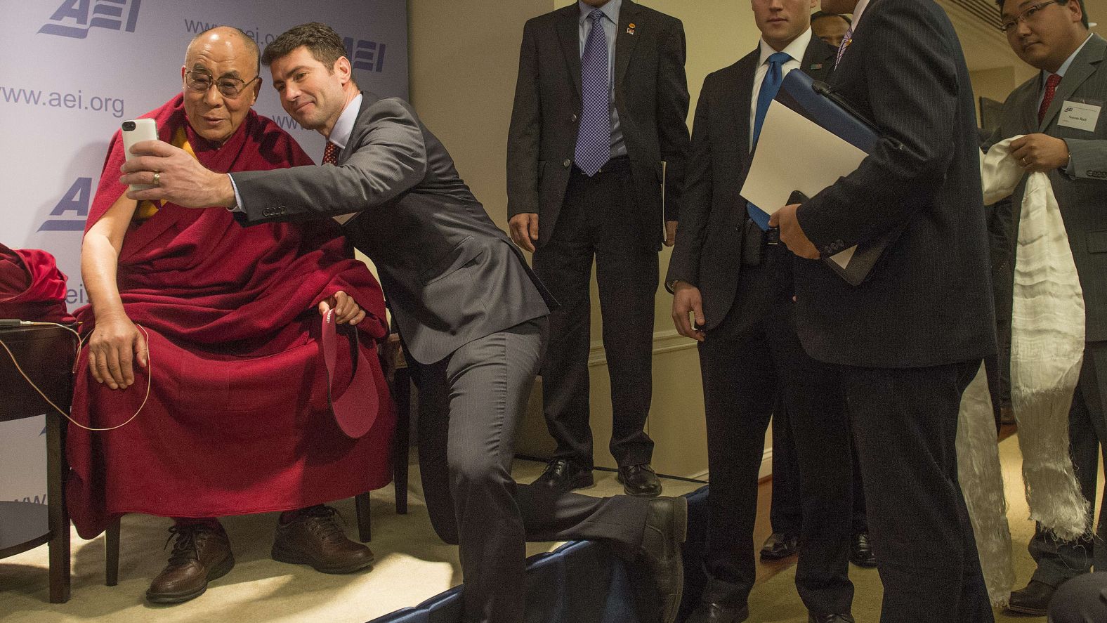 Blogger Alek Boyd takes a selfie with the Dalai Lama at the American Enterprise Institute in Washington during a break between panel discussions on "Happiness, Free Enterprise, and Human Flourishing" on February 20, 2014.