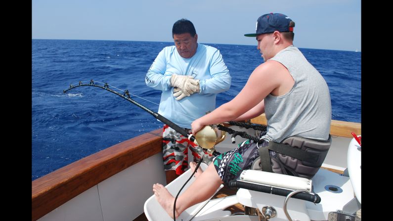 It took Kai Rizzuto, right, 30 minutes to reel in the blue marlin under Arai's guidance.
