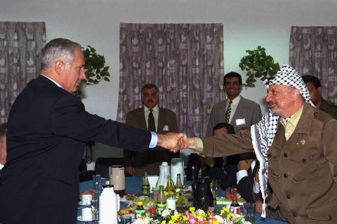 Netanyahu meets with Palestinian leader Yasser Arafat for the first time on September 4, 1996, at an Israeli army base at the Erez Checkpoint in Gaza.