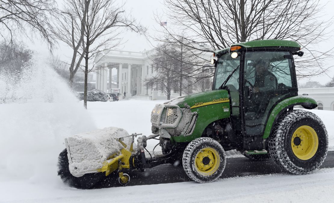 Snow is cleared on the North side of the White House in Washington, Saturday, February 21.