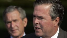 Caption:Washington, UNITED STATES: US President George W. Bush (L) looks on as his brother Florida Governor Jeb Bush speaks 19 April, 2006. Governor Bush was among several governors who met with the president after an Easter trip to Iraq, Afghanistan and Kuwait. AFP PHOTO/Jim WATSON (Photo credit should read JIM WATSON/AFP/Getty Images)