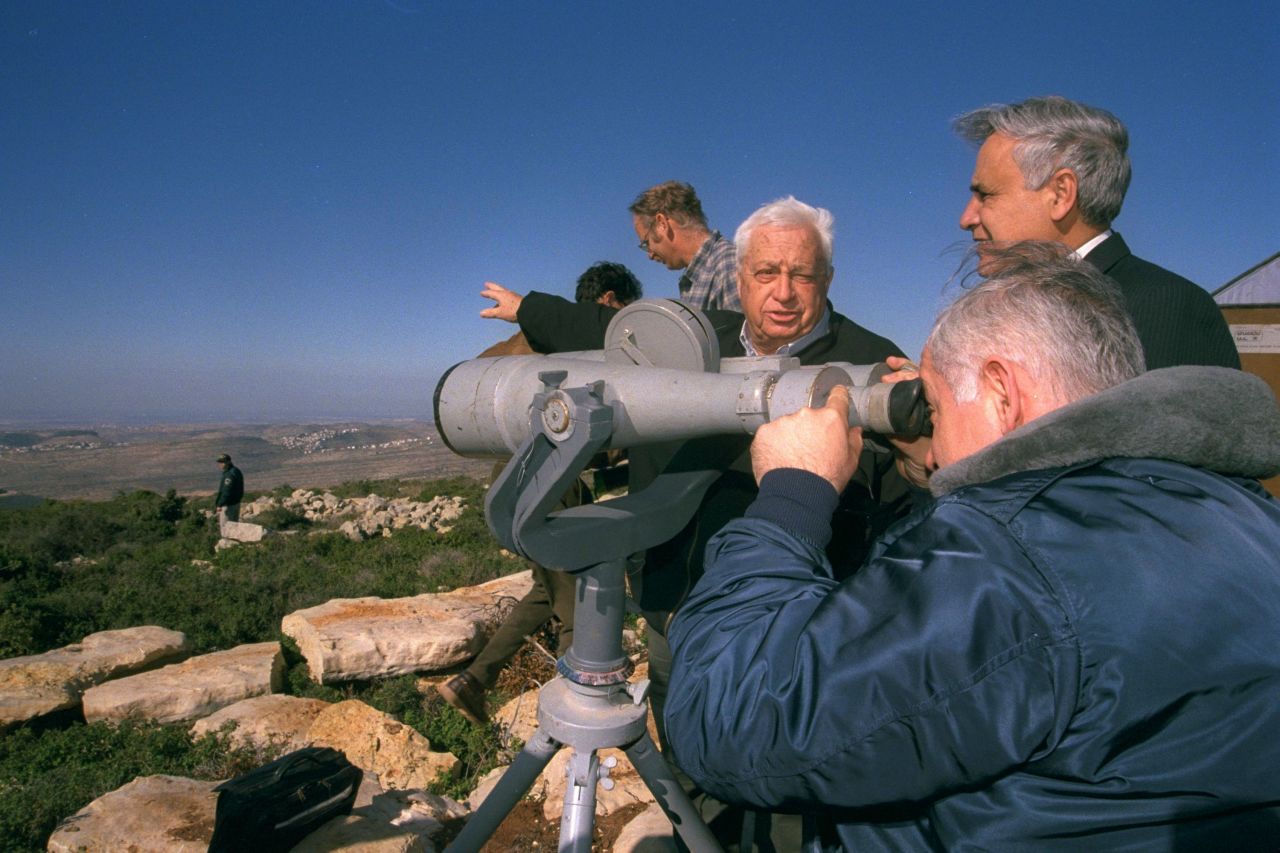 Netanyahu looks through binoculars as he and the Israeli Cabinet tour the West Bank in December 1997.