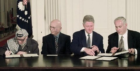 From left, Arafat, King Hussein, US President Bill Clinton and Netanyahu sign an interim Middle East peace agreement in October 1998.