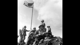 This is the first flag raising on the top of Mt. Suribachi. The famous flag-raising photo was taken when the second flag was put up later that day.