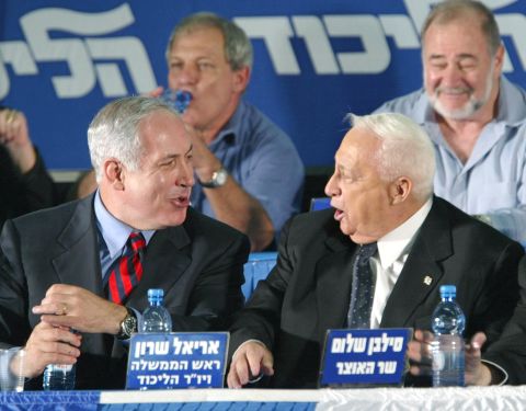 Netanyahu, as Israel's foreign minister, laughs with Israeli Prime Minister Ariel Sharon at the start of a Likud convention in Tel Aviv, Israel, in November 2002.