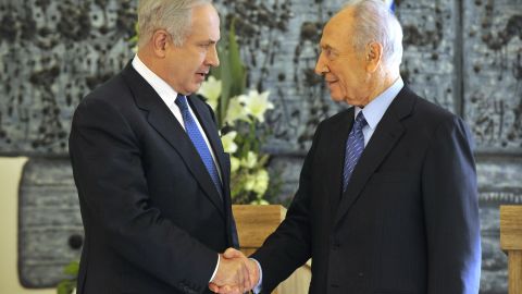 Netanyahu shakes hands with Israeli President Shimon Peres in February 2009 after Netanyahu won backing from the Israeli parliament to become Prime Minister again. A close election between Netanyahu and rival Tzipi Livni had left the results unclear until the parliament's decision.
