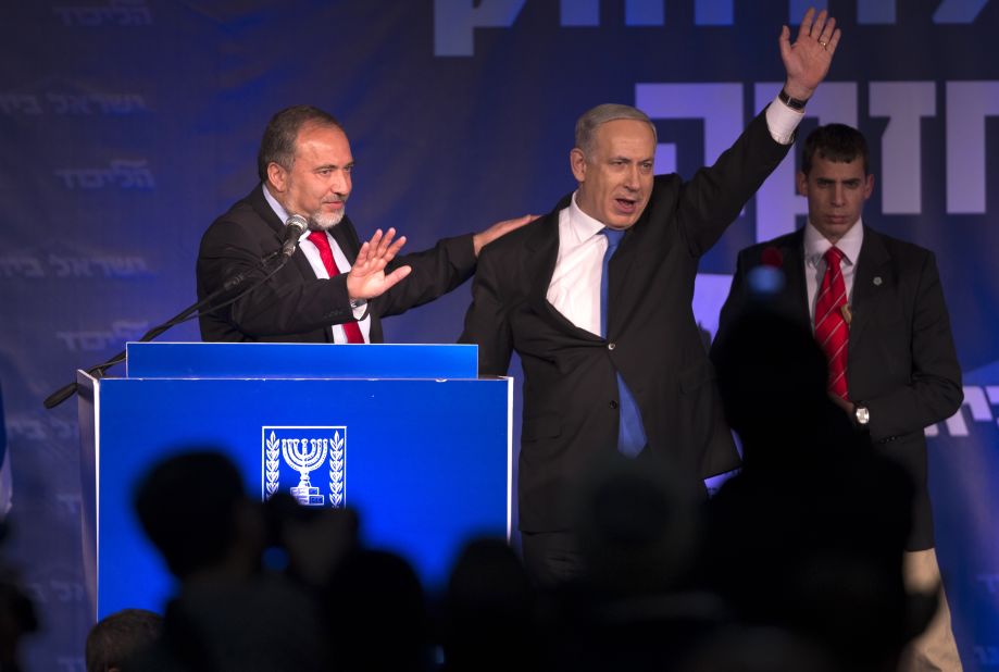 Netanyahu and Avigdor Lieberman of the Likud-Beiteinu coalition party greet supporters as they arrive on stage on election night in January 2013.