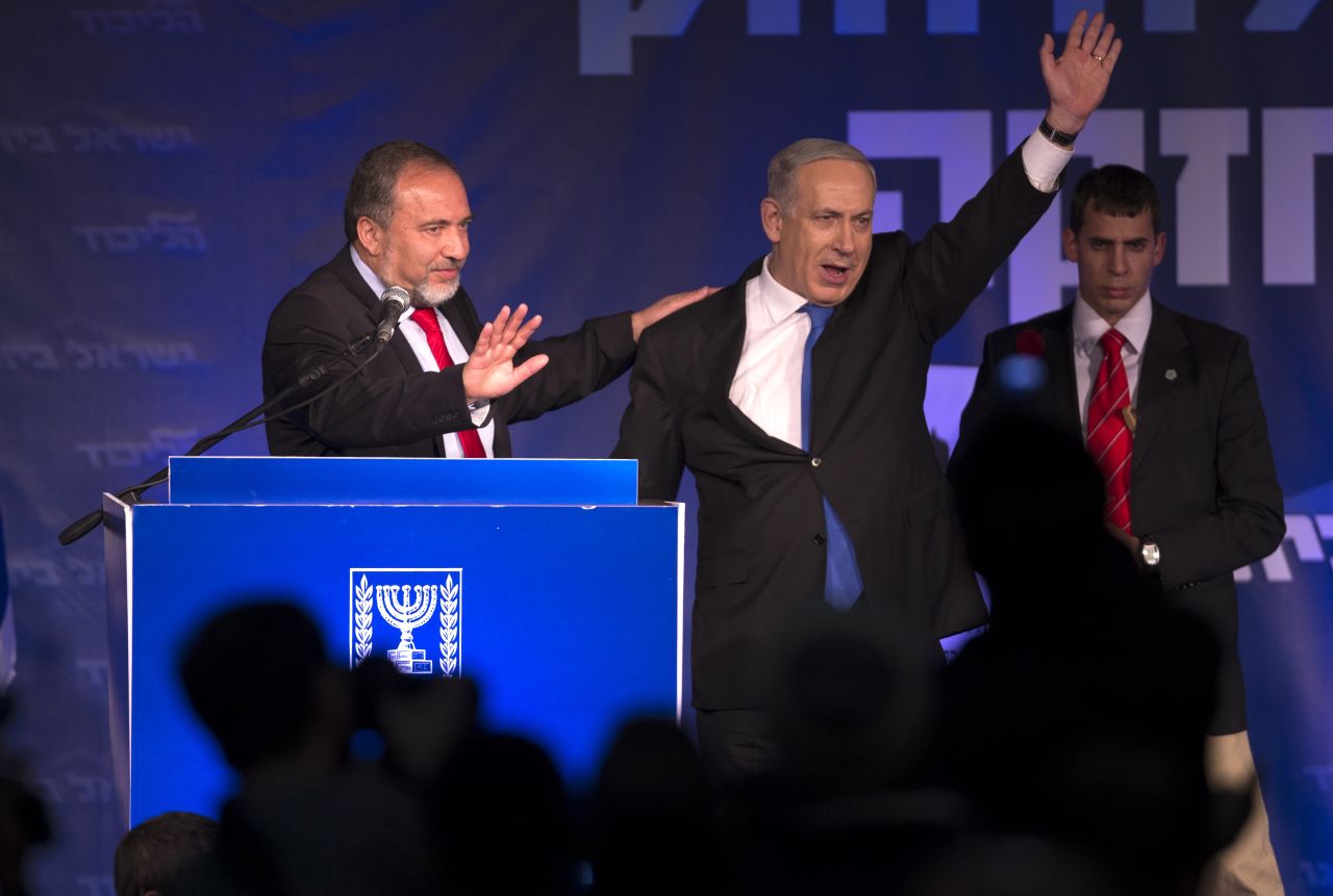 Netanyahu and Avigdor Lieberman of the Likud-Beiteinu coalition party greet supporters as they arrive on stage on election night in January 2013.