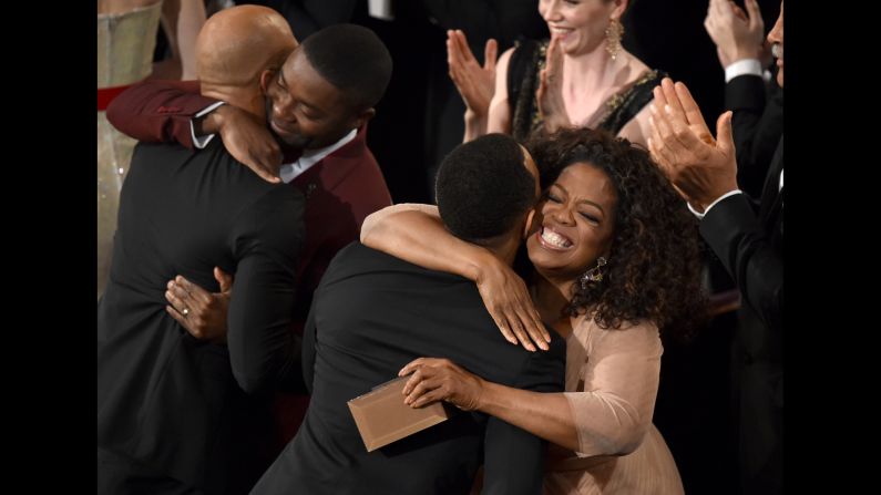 Common, far left, and John Legend are congratulated by actor David Oyelowo and Oprah Winfrey after winning the Oscar for best original song.