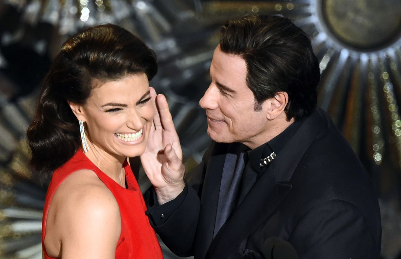 John Travolta and Idina Menzel present an award together, <a href="http://www.cnn.com/2014/03/04/showbiz/john-travolta-idina-menzel-oscars/index.html" target="_blank">referencing last year's flub</a> when he mispronounced her name.
