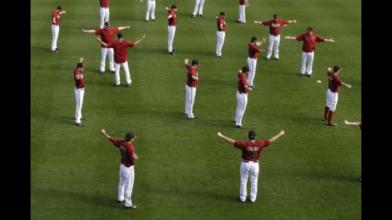 The Arizona Diamondbacks stretch during spring training Sunday, February 22, in Scottsdale, Arizona. The Major League Baseball season begins on April 5.