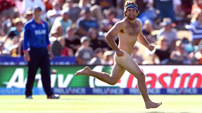 A man streaks past an England player during a Cricket World Cup match in Christchurch, New Zealand, on Monday, February 23.