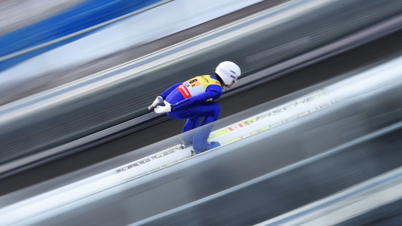 In this photo, taken using a slow shutter speed, Austrian ski jumper Sepp Schneider practices Sunday, February 22, at the Nordic World Ski Championships.