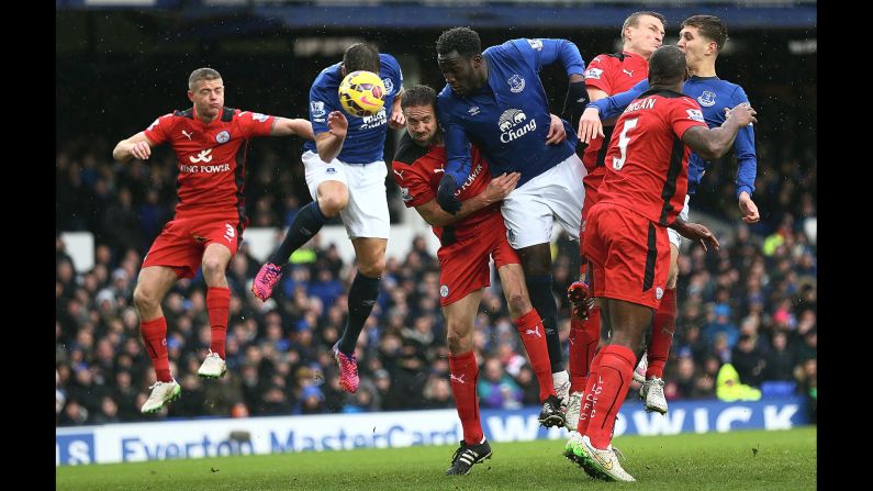 Everton players, in blue, compete for a header with Leicester City players during a Premier League match Sunday, February 22, in Liverpool, England.