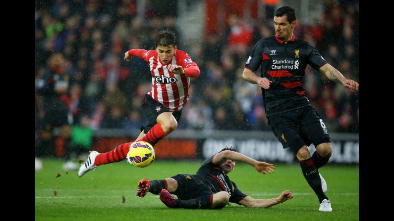 Southamption's Filip Djuricic, left, is tackled by Liverpool's Joe Allen during a Premier League match played Sunday, February 22, in Southampton, England.