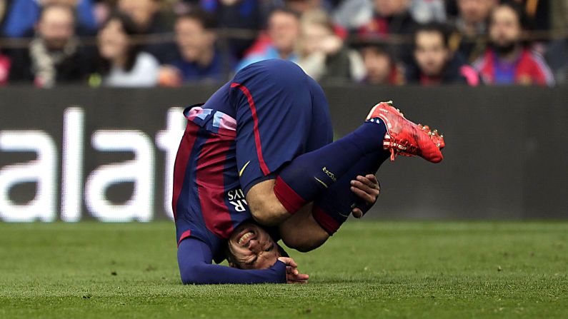 Barcelona forward Luis Suarez falls to the ground Saturday, February 21, during a Spanish league match against Malaga in Barcelona, Spain. Malaga upset the home team 1-0.