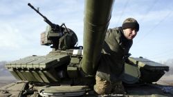 A Ukrainian serviceman climbs out of a Ukrainian army tank at a checkpoint near Horlivka, in the region of Donetsk, on February 23, 2015.