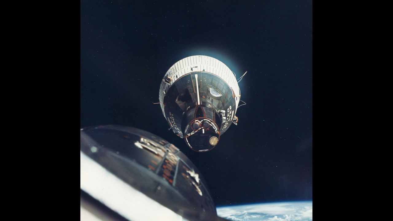Traveling at 17,000 mph, the Gemini 6 crew flies to within inches of the orbiting Gemini 7 spacecraft in December 1965. It was the first rendezvous in space.
