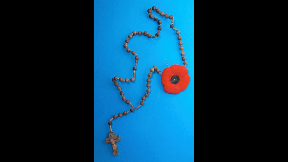 A rosary with a Remembrance Day poppy hung from a nail on the wall of mysterious Toronto tunnel. 