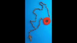 A rosary with a Remembrance Day poppy hung from a nail on the wall of the mysterious Toronto tunnel. 