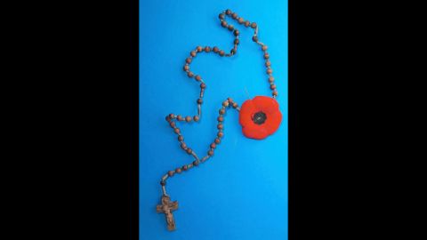 A rosary with a Remembrance Day poppy hung from a nail on the wall of the mysterious Toronto tunnel.